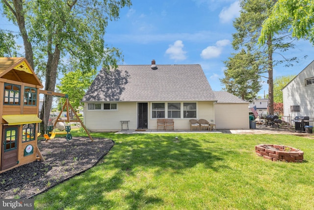 15 Wildflower Rd, Levittown, PA 19057 - rear view of property with a playground, a fire pit, a patio, a shingled roof, and a yard