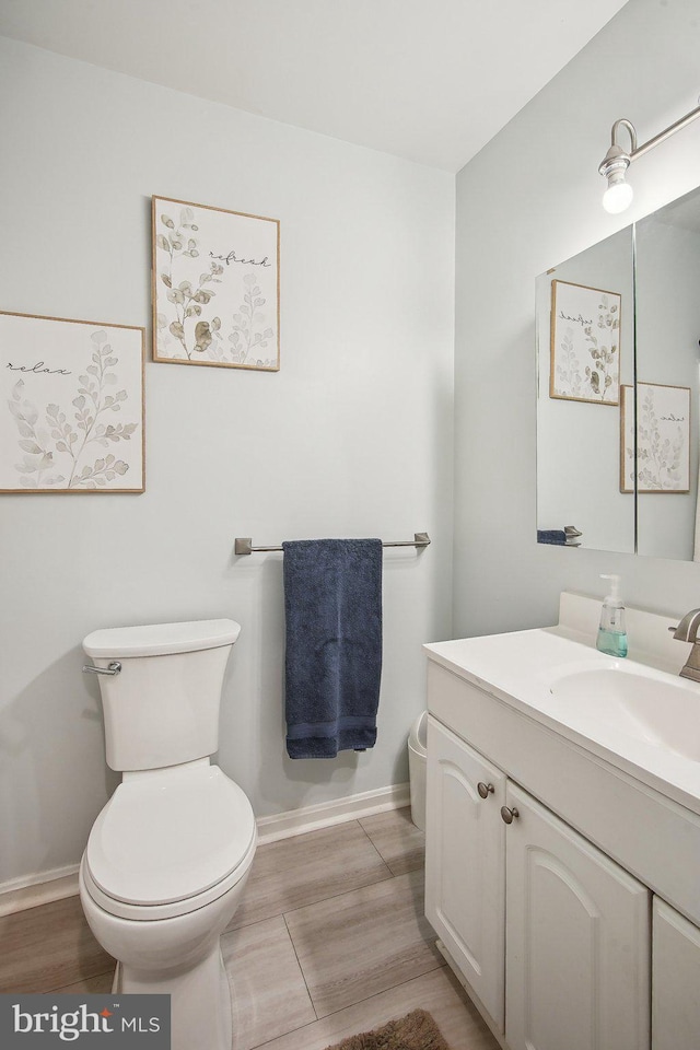 1838 Sherman Dr, Chester, MD 21619 - half bathroom with toilet, baseboards, vanity, and wood finished floors