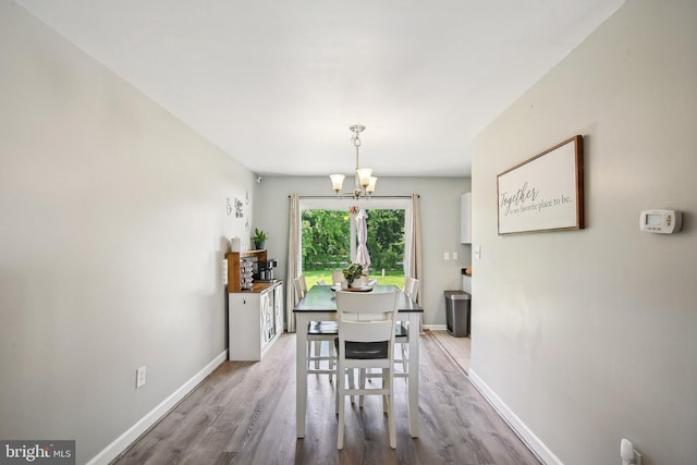 1838 Sherman Dr, Chester, MD 21619 - dining space featuring a chandelier, baseboards, and wood finished floors