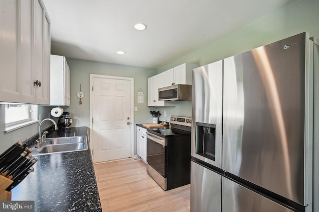 1838 Sherman Dr, Chester, MD 21619 - kitchen featuring stainless steel appliances, a sink, white cabinetry, light wood-style floors, and recessed lighting