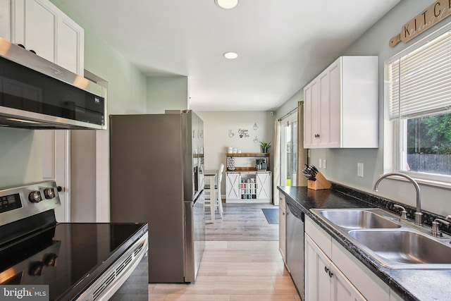 1838 Sherman Dr, Chester, MD 21619 - kitchen with stainless steel appliances, a sink, white cabinets, recessed lighting, and dark countertops