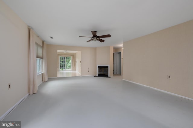 5 Keswick Ct, Mount Laurel, NJ 08054 - unfurnished living room featuring a fireplace with flush hearth, a ceiling fan, concrete flooring, and baseboards