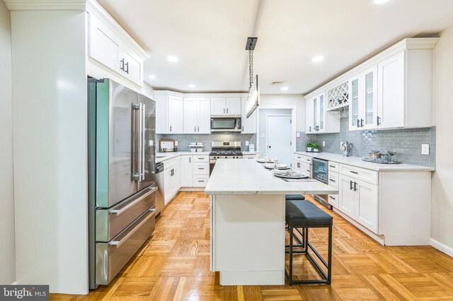 44 S Brookside Rd, Springfield, PA 19064 - kitchen featuring appliances with stainless steel finishes, white cabinets, tasteful backsplash, and recessed lighting