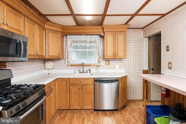 11 Langdon Rd, Burlington, NJ 08016 - kitchen with appliances with stainless steel finishes, a sink, light wood finished floors, light countertops, and tile walls