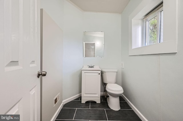 118 N Hilton St, Baltimore, MD 21229 - bathroom with vanity, toilet, baseboards, and tile patterned flooring