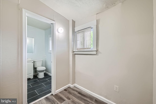 118 N Hilton St, Baltimore, MD 21229 - bathroom featuring toilet, wood finished floors, and baseboards