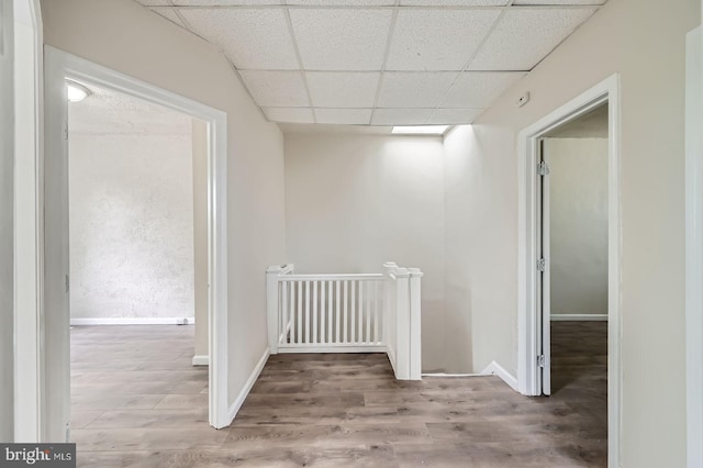 118 N Hilton St, Baltimore, MD 21229 - corridor with an upstairs landing, a drop ceiling, wood finished floors, and baseboards