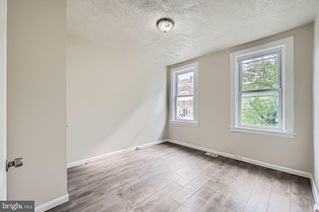 118 N Hilton St, Baltimore, MD 21229 - unfurnished room with baseboards, wood finished floors, and a textured ceiling