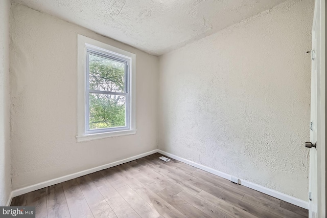 118 N Hilton St, Baltimore, MD 21229 - unfurnished room with baseboards, wood finished floors, a textured wall, and a textured ceiling