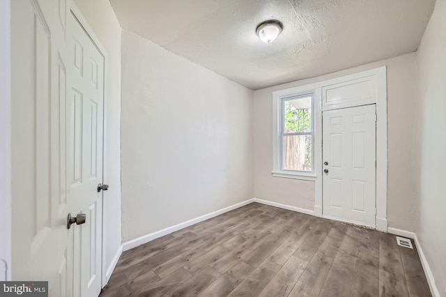 118 N Hilton St, Baltimore, MD 21229 - foyer entrance with baseboards, wood finished floors, and a textured ceiling