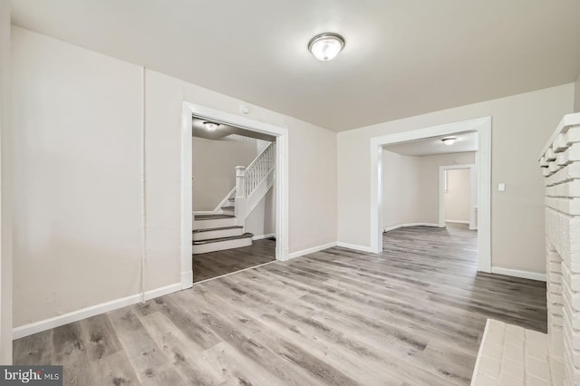 118 N Hilton St, Baltimore, MD 21229 - spare room featuring stairs, wood finished floors, and baseboards