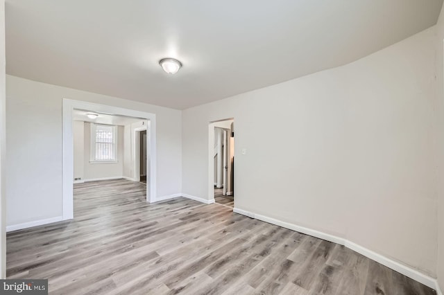 118 N Hilton St, Baltimore, MD 21229 - spare room featuring light wood-style floors and baseboards