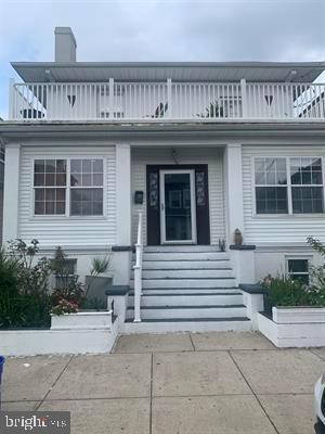 19 S Elberon Ave, Atlantic City, NJ 08401 - doorway to property with a balcony, a porch, and a chimney
