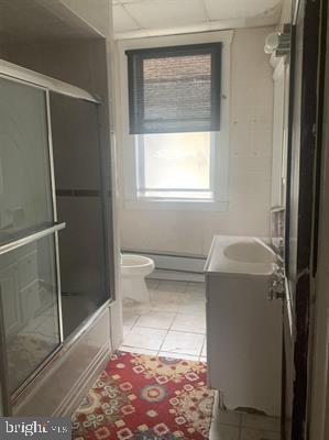 19 S Elberon Ave, Atlantic City, NJ 08401 - bathroom with toilet, tile patterned flooring, vanity, and a baseboard radiator