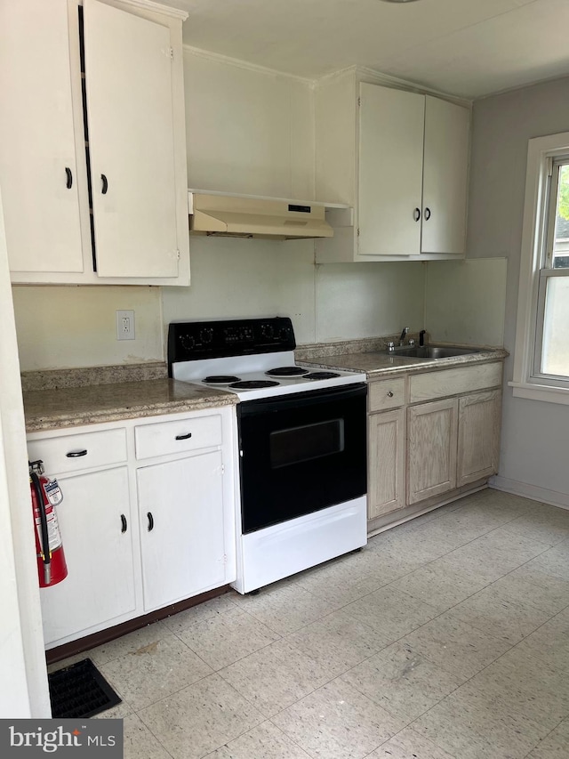 1208 First Ave, Seabrook, NJ 08302 - kitchen with range with electric stovetop, under cabinet range hood, a sink, light countertops, and baseboards