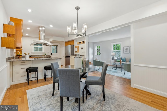 8404 Galveston Rd, Silver Spring, MD 20910 - dining space with light wood-type flooring, a chandelier, recessed lighting, and a wainscoted wall