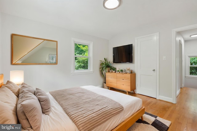 8404 Galveston Rd, Silver Spring, MD 20910 - bedroom with multiple windows, light wood-style floors, and baseboards