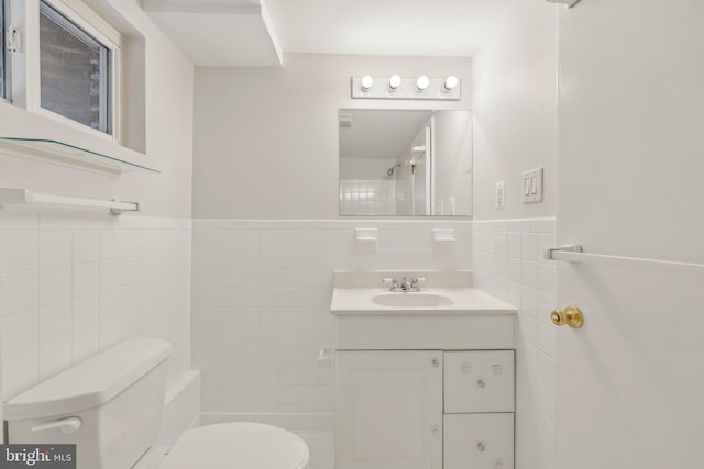 8404 Galveston Rd, Silver Spring, MD 20910 - bathroom featuring tile walls, toilet, vanity, and a wainscoted wall
