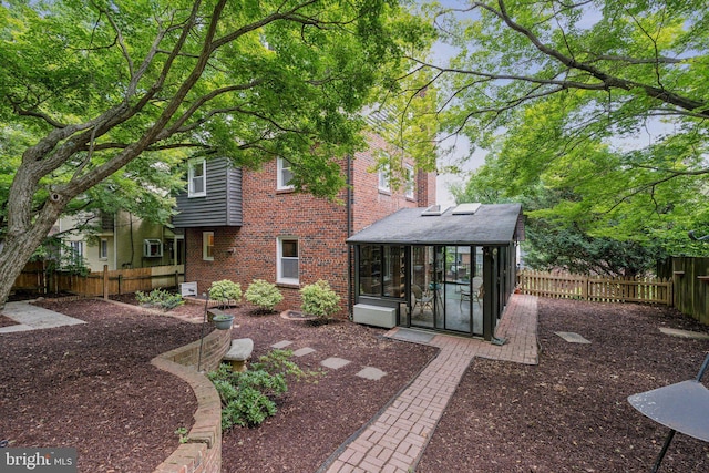 8404 Galveston Rd, Silver Spring, MD 20910 - rear view of house with a sunroom, a fenced backyard, and brick siding