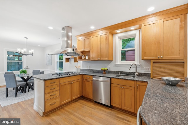 8404 Galveston Rd, Silver Spring, MD 20910 - kitchen featuring stainless steel appliances, island exhaust hood, a sink, light wood finished floors, and a peninsula
