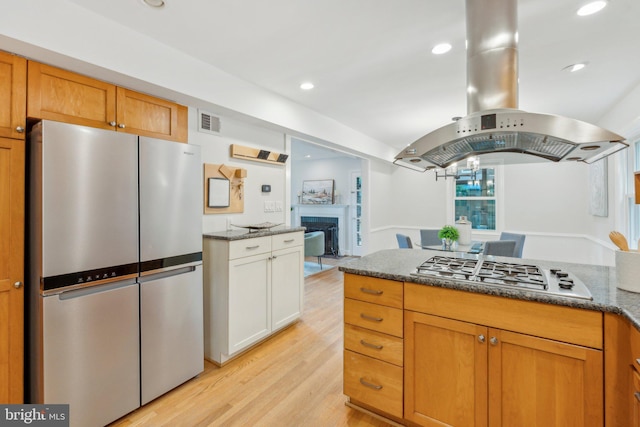 8404 Galveston Rd, Silver Spring, MD 20910 - kitchen with appliances with stainless steel finishes, light wood finished floors, a fireplace, dark stone countertops, and recessed lighting