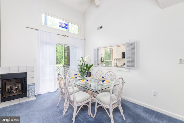 33340 Timberview Ct Unit 21003, Bethany Beach, DE 19930 - carpeted dining area featuring high vaulted ceiling, a fireplace, and baseboards
