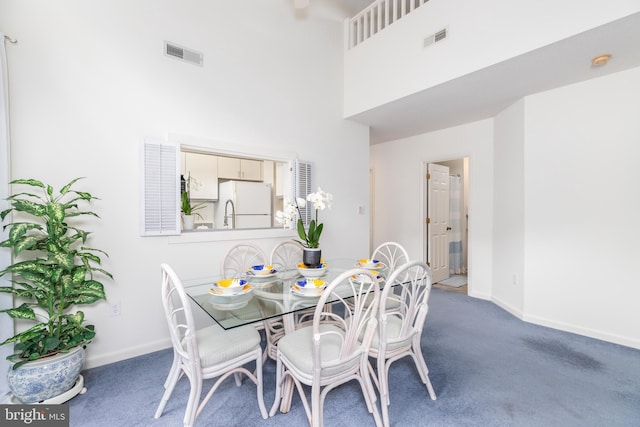 33340 Timberview Ct Unit 21003, Bethany Beach, DE 19930 - carpeted dining room with a towering ceiling and baseboards