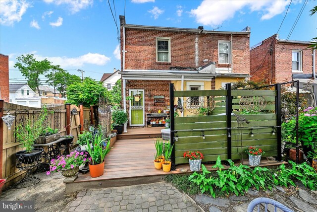 4224 Evans Chapel Rd, Baltimore, MD 21211 - back of house featuring brick siding, a fenced backyard, and a deck