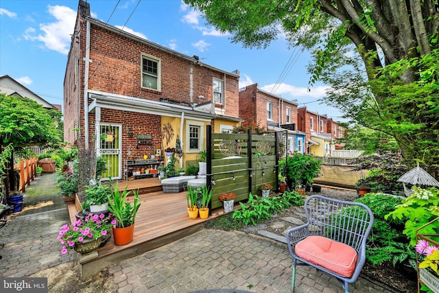 4224 Evans Chapel Rd, Baltimore, MD 21211 - rear view of house with brick siding, a deck, and a patio