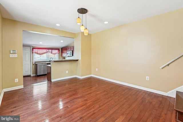 3603 6th St, Baltimore, MD 21225 - unfurnished living room featuring dark wood-style flooring, baseboards, a sink, and recessed lighting