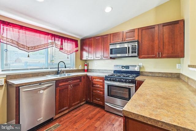 3603 6th St, Baltimore, MD 21225 - kitchen featuring appliances with stainless steel finishes, a sink, lofted ceiling, dark wood-style floors, and light countertops