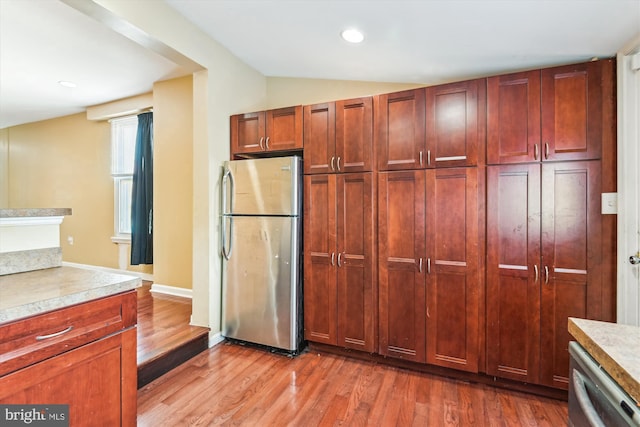 3603 6th St, Baltimore, MD 21225 - kitchen featuring appliances with stainless steel finishes, wood finished floors, light countertops, vaulted ceiling, and recessed lighting