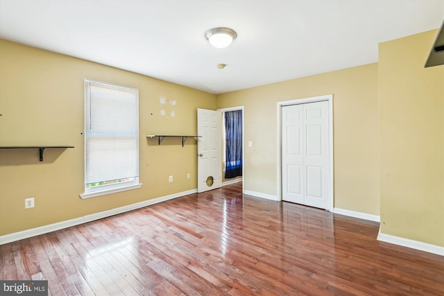 3603 6th St, Baltimore, MD 21225 - unfurnished bedroom with hardwood / wood-style floors, baseboards, and a closet