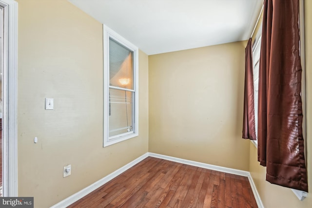 3603 6th St, Baltimore, MD 21225 - spare room featuring baseboards and wood finished floors