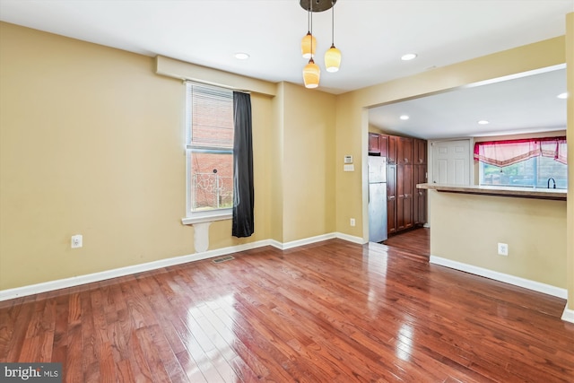 3603 6th St, Baltimore, MD 21225 - unfurnished living room featuring dark wood-type flooring, baseboards, and recessed lighting