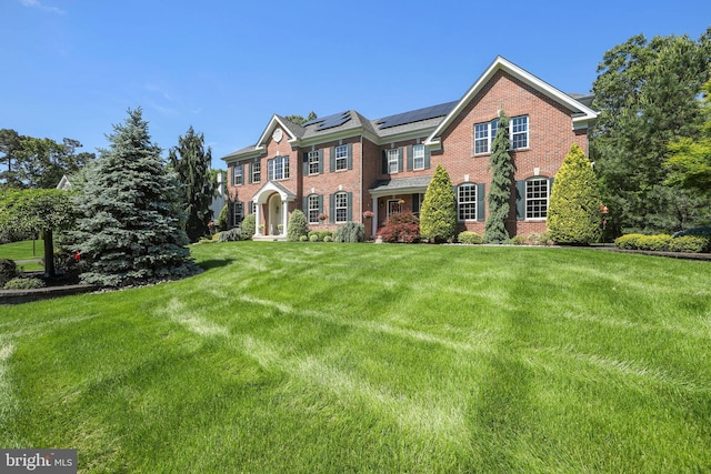 60 Sleepy Hollow Dr, Tabernacle, NJ 08088 - colonial house with brick siding, solar panels, and a front yard