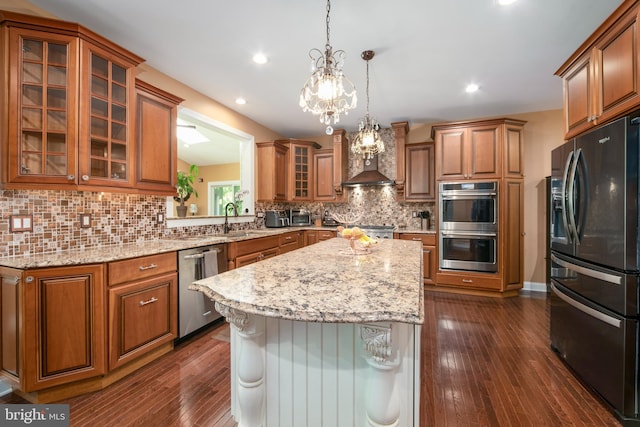 60 Sleepy Hollow Dr, Tabernacle, NJ 08088 - kitchen with stainless steel appliances, brown cabinets, a center island, dark wood-type flooring, and decorative backsplash
