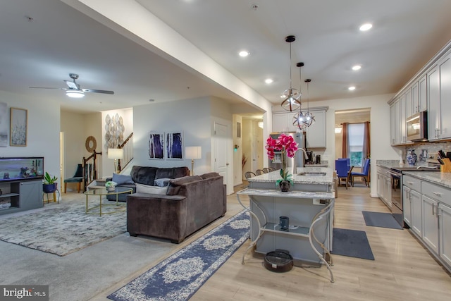16600 Tortola Dr, Accokeek, MD 20607 - living room with light wood finished floors, stairs, recessed lighting, and a ceiling fan