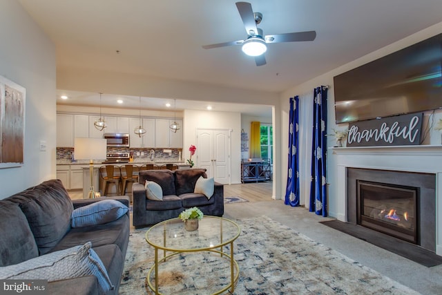 16600 Tortola Dr, Accokeek, MD 20607 - living area with a ceiling fan, a fireplace with flush hearth, light colored carpet, and recessed lighting