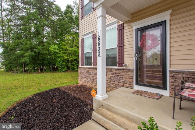 16600 Tortola Dr, Accokeek, MD 20607 - doorway to property featuring stone siding and a yard