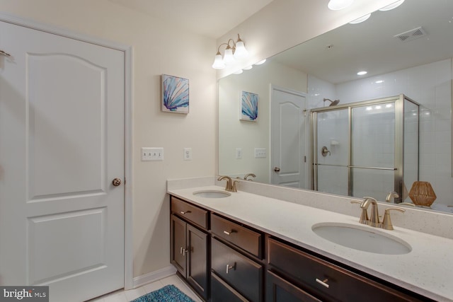 16600 Tortola Dr, Accokeek, MD 20607 - full bath featuring double vanity, a shower stall, tile patterned floors, and baseboards