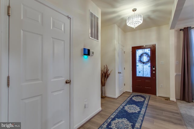 16600 Tortola Dr, Accokeek, MD 20607 - foyer featuring a chandelier, baseboards, and light wood-style flooring