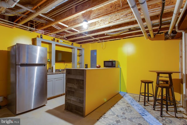 16600 Tortola Dr, Accokeek, MD 20607 - unfinished below grade area with freestanding refrigerator and bar area