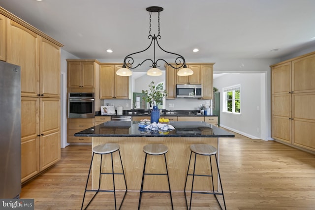 3403 Niagara Rd, Annapolis, MD 21403 - kitchen featuring stainless steel appliances, a breakfast bar, light brown cabinets, recessed lighting, and a center island