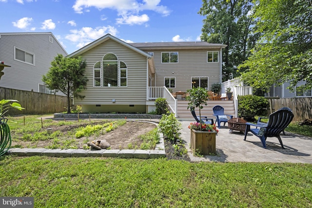 3403 Niagara Rd, Annapolis, MD 21403 - rear view of property featuring crawl space, an outdoor fire pit, a patio, a garden, and a wooden deck