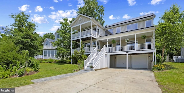 3403 Niagara Rd, Annapolis, MD 21403 - raised beach house with a porch, a front yard, an attached garage, concrete driveway, and stairway