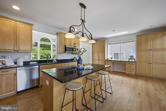 3403 Niagara Rd, Annapolis, MD 21403 - kitchen featuring stainless steel appliances, a kitchen bar, light wood finished floors, a kitchen island, and recessed lighting