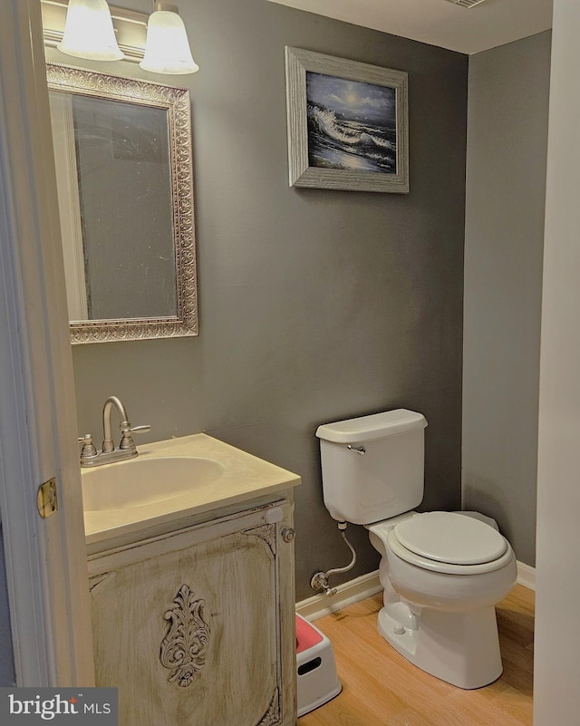 1106 Crestmont Dr, Mantua, NJ 08051 - half bath featuring toilet, wood finished floors, vanity, and baseboards