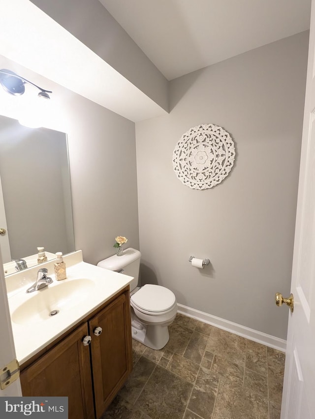 513 Dakemich Ct, Enola, PA 17025 - bathroom with toilet, vanity, stone finish floors, and baseboards
