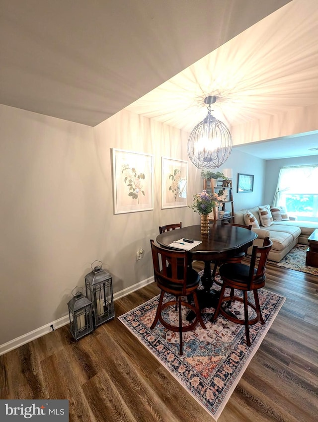 513 Dakemich Ct, Enola, PA 17025 - dining room featuring a chandelier, wood finished floors, and baseboards